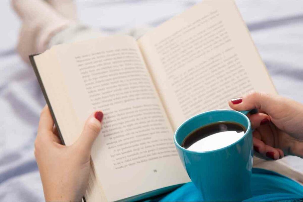 deliberate rest: person reading book with feet up and cup of coffee